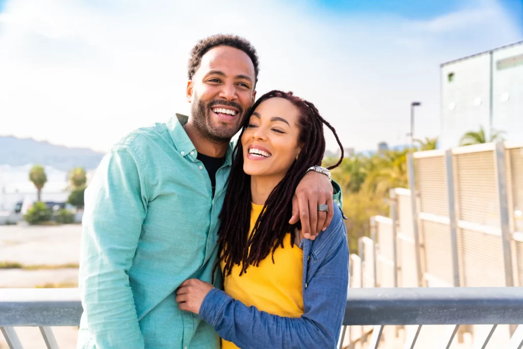 happy couple embrace on a bridge utc